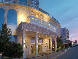 a building with a sign on the side of it at Crixus Hotels Duhok in Duhok