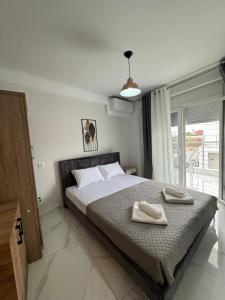 a bedroom with a bed with two towels on it at Studio AZOTI in Kástron