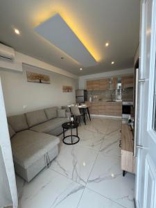 a living room with a couch and a kitchen at Studio AZOTI in Kástron
