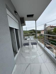 a balcony with a table and chairs on it at Studio AZOTI in Kástron