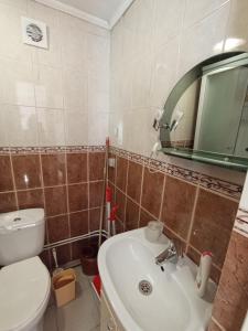 a bathroom with a toilet and a sink and a mirror at Котедж - Prestige in Vorokhta