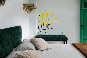 a bedroom with a bed and a green couch at Origen Hostel Jardín in Jardin