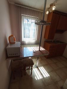 a kitchen with a table with a microwave and a window at Котедж - Prestige in Vorokhta +6 photos