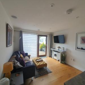 a living room with a couch and a table at The Nook in Inverness