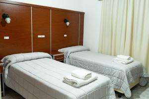 a room with two beds with towels on them at City Hotel Termal in Termas de Río Hondo +26 photos