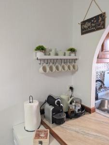a kitchen with a counter with pots and a sink at Jardín secreto del Mar Menor, La Manga in San Javier
