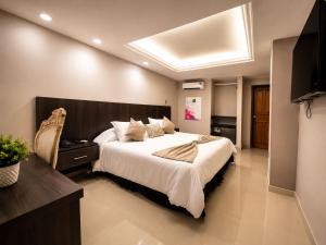 a bedroom with a large bed and a television at Fontamar 43 in Barranquilla
