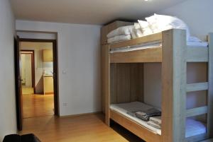 a room with two bunk beds and a hallway at Buranka Apartment in Jablonec nad Jizerou