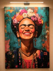 a painting of a woman with flowers on her head at La Casita Rosa in Valras-Plage