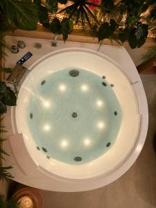 a jacuzzi tub in a room with plants at La Casita Rosa in Valras-Plage +12 photos