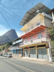 a building on a street with a mountain in the background at Casa Zago 2 in Santa Maria Madalena