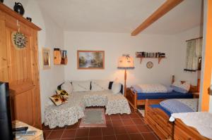 um quarto com 2 camas, uma mesa e um candeeiro em Ferienwohnungen M Cichini em Millstatt