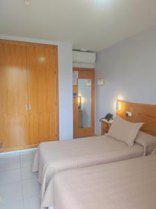 a hotel room with two beds and a mirror at Balcones Azules in Cartagena +27 photos