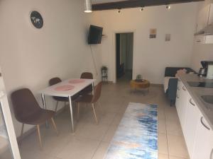 a kitchen and dining room with a table and chairs at Apartman deluxe sea in Split