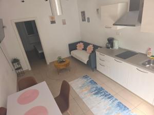a kitchen with a couch and a table in a room at Apartman deluxe sea in Split