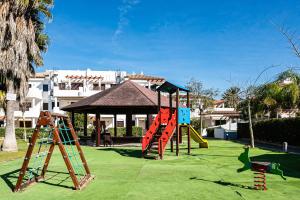 a playground with a slide and a play structure at coto 4 11 in Novo Sancti Petri