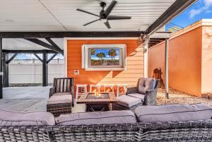 a patio with furniture and a ceiling fan at Ocean Lakes Walk to beach! Waterpark! Arcade! Dogs Welcome! in Myrtle Beach
