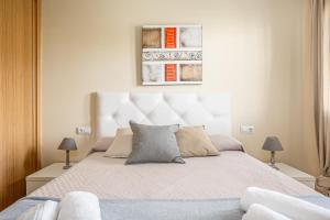 a bedroom with a large bed with two lamps at coto 4 11 in Novo Sancti Petri +26 photos