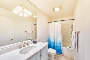 a white bathroom with a sink and a toilet at Saltwater & Sunsets in Long Beach +12 photos