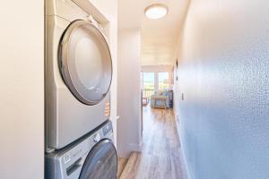a washer and dryer in a room with a hallway at Saltwater & Sunsets in Long Beach
