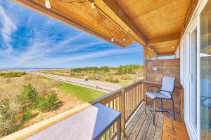a balcony with a chair and a view of the ocean at Saltwater & Sunsets in Long Beach