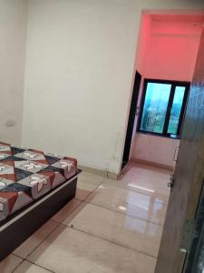 a bedroom with a bed and a door with a window at New MORVINAND PALACE in Khātu