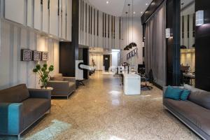 a lobby with couches and tables in a building at Lobie Queen Ipanema in Rio de Janeiro