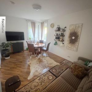 a living room with a table and a dining room at Ferienwohnung in Göppingen