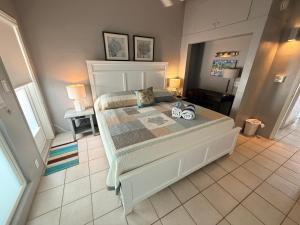 a bedroom with a bed with two shoes on it at Sea Crest in Sarasota +66 photos