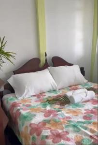 a bed with two pillows on top of it at CJ's Creole Hideaway in Castries