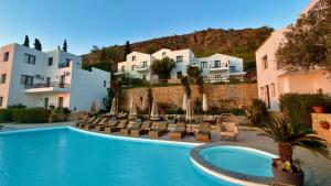 a swimming pool with lounge chairs and buildings at Creta Blue Boutique Hotel in Hersonissos