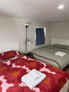 a bedroom with two beds with towels on them at Bright Spacious Room-3B in Halifax