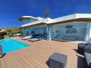 a house with a swimming pool and a wooden deck at Villa Luxury Paradise in Salobreña