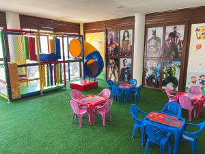 a room with colorful tables and chairs in a play room at El Aram Imirá Beach Resort in Natal
