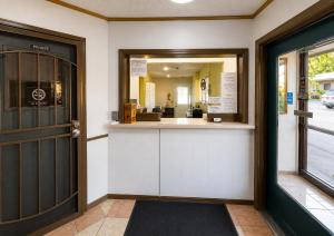 a front door of a restaurant with a mirror at Skyline Motel Bartlesville Hwy 75 in Bartlesville