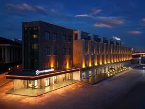 a building with a sign on it at night at Park Dedeman Konya in Konya