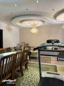 a living room with a couch and a table and chairs at عمان - ضاحية النخيل in Amman