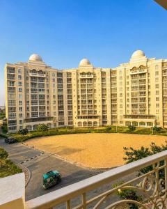 a large building with a car parked in front of it at Blue Mans Rooms - Near Prem Mandir & ISKCON in Vrindāvan