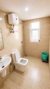 a bathroom with a white toilet and a sink at Blue Mans Rooms - Near Prem Mandir & ISKCON in Vrindāvan +36 photos