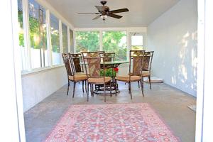 a dining room with a table and chairs and a ceiling fan at Manatee River Bungalow - 4 in Bradenton