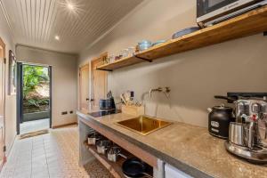 a kitchen with a sink and a counter top at Bali Suites - Sanur suite in Willemstad