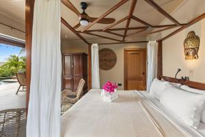 a bedroom with a bed with flowers on it at Bali Suites - Sanur suite in Willemstad