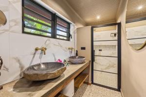 a bathroom with two sinks on a counter at Bali Suites - Sanur suite in Willemstad +15 photos