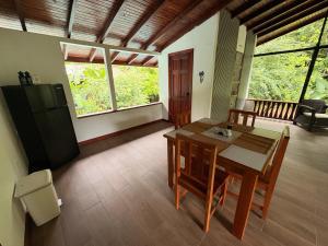 a kitchen and dining room with a table and a refrigerator at Pacheco Villa in Drake