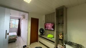 a kitchen with a picture of a man on the wall at Flat Bela Amarração in Luis Correia +9 photos