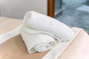 a stack of towels sitting on top of a bed at Villa Anna in Meta +100 photos