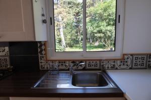 a kitchen with a sink and a window above it at Container Maritime Montagne Noire in Fontiers-Cabardès +84 photos