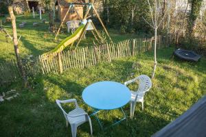 a blue table and two chairs and a playground at Container Maritime Montagne Noire in Fontiers-Cabardès