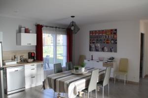 een keuken en eetkamer met een tafel en stoelen bij Gîte de Roches Hibou in Seigy