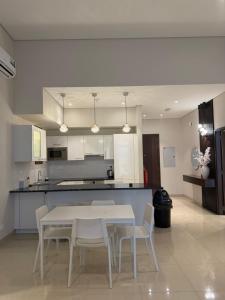 a kitchen with a table and chairs in a room at Beach front 414 villa private pool in Muscat